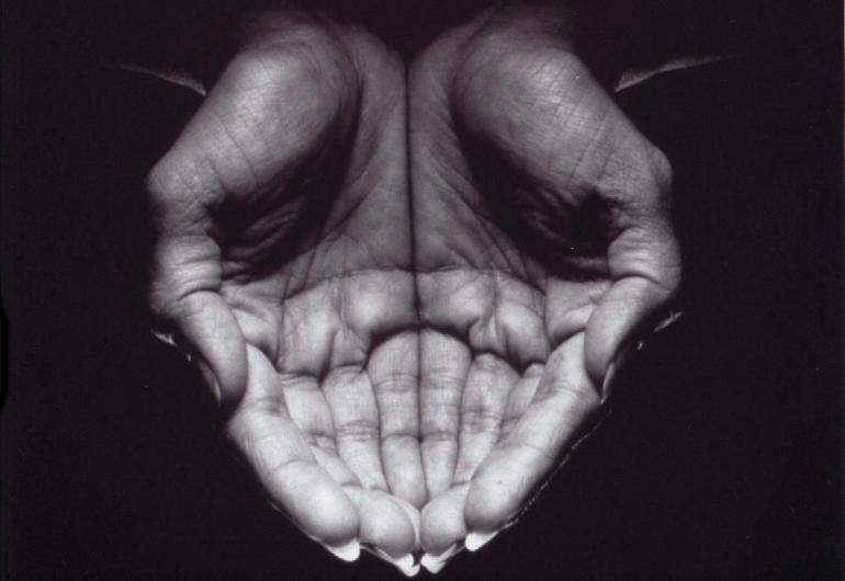 overhead close up of hands cupped tightly together