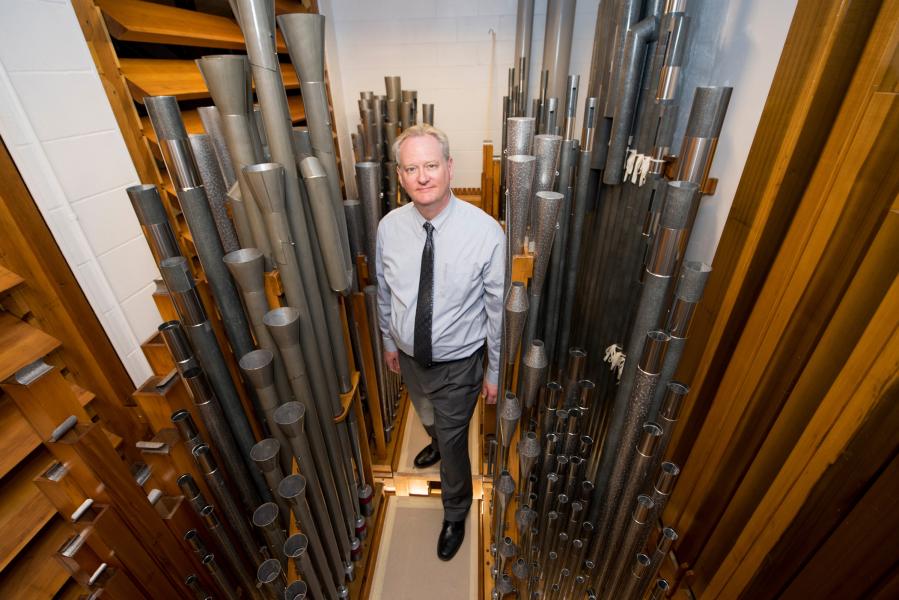 Dean standing amongst the Northrop organ pipes.
