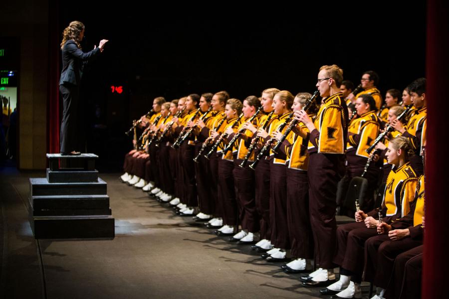 The marching band performing on the Northrop stage.