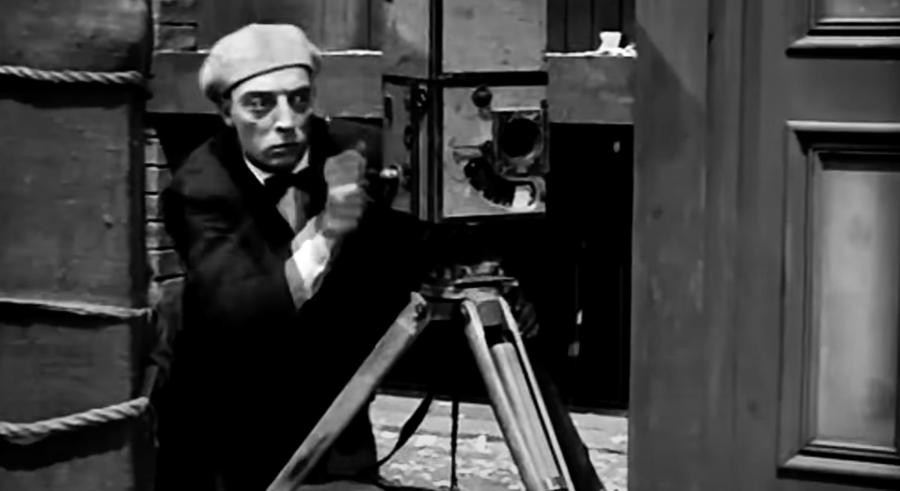 Buster Keaton with a tripod, in a still from The Cameraman.