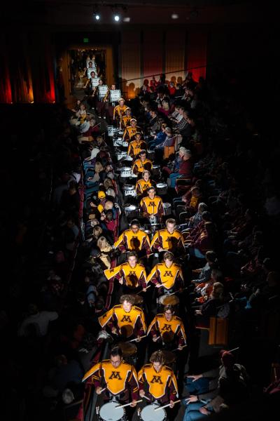 View from above of UMN drummers marching in a line.