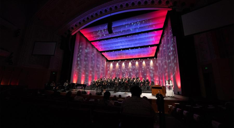 Red and blue colors fill the stage during a VocalEssence performance.