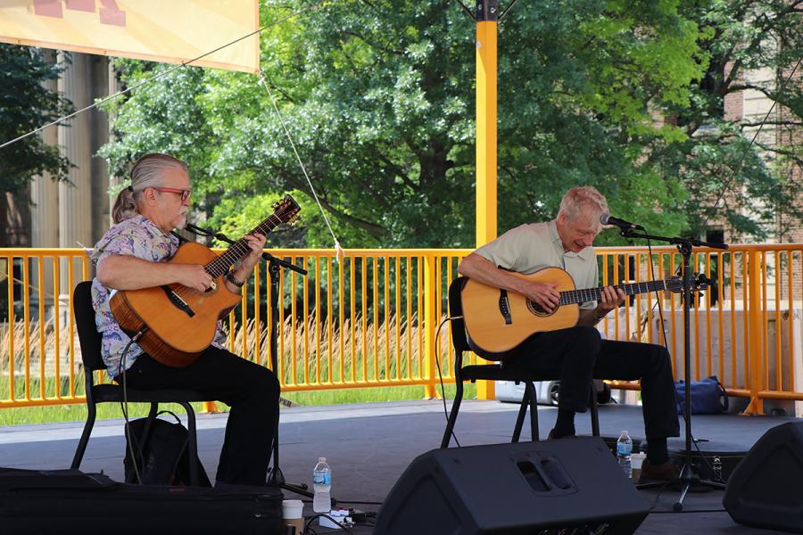 Tim Sparks and Phil Heywood playing their guitars on stage July 24.