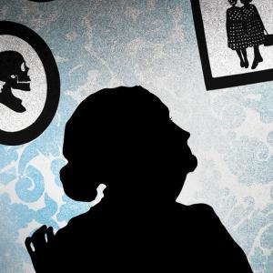 shadow silhouette of elderly woman looking at pictures on a patterned wall