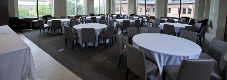 Lindahl Founders Room filled with white draped round tables.