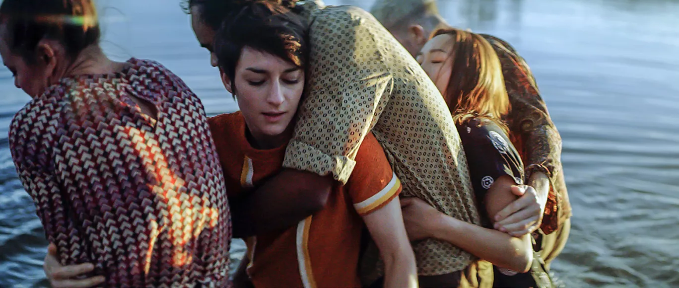 GALLIM dancers gather in the water touching or hugging eachother