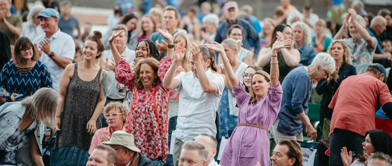Audience members standing and applauding.