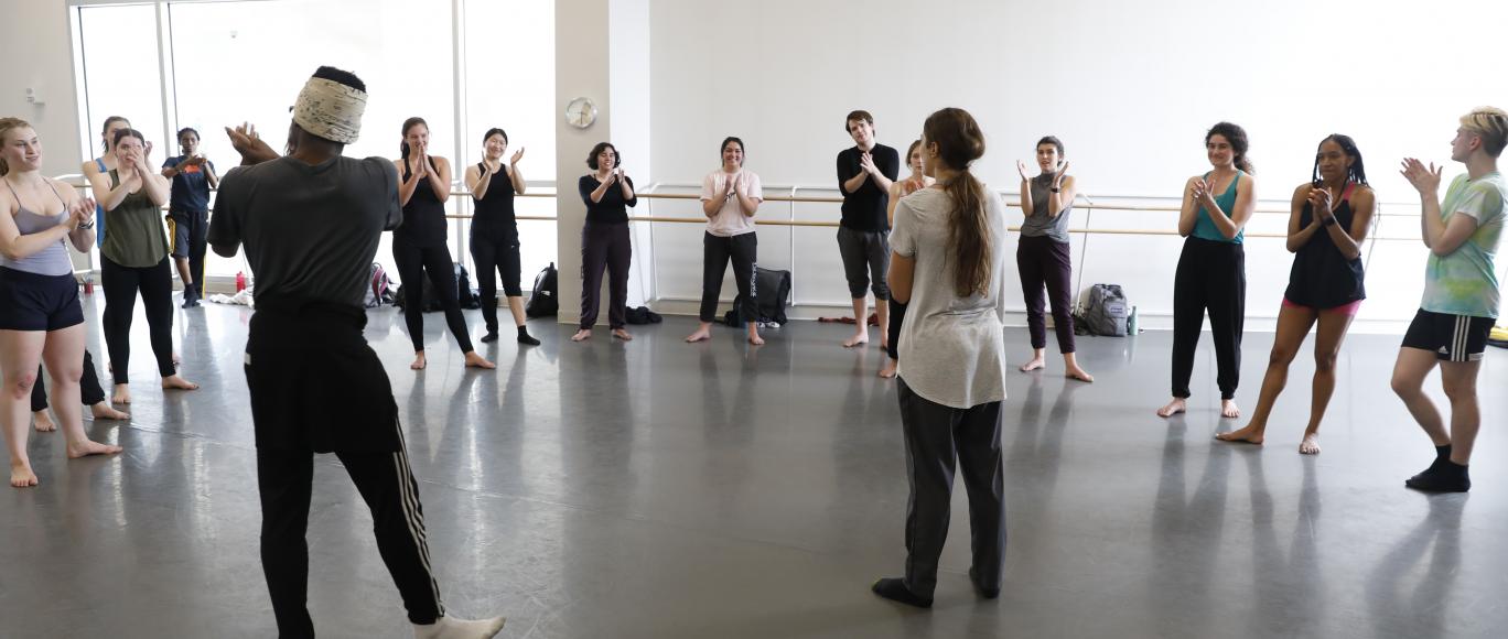A group of students participate in a dance class.