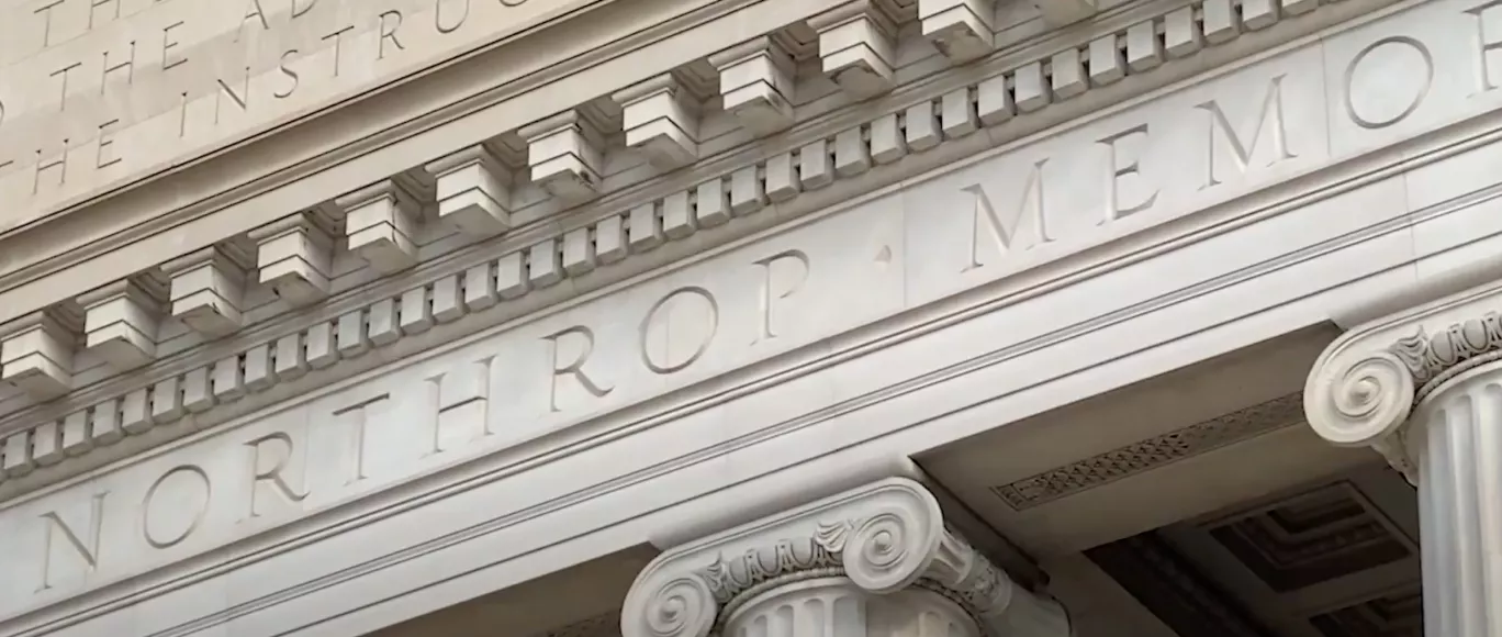 Close-up of name Northrop engraved into stone on the facade of the building.