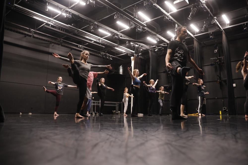 Students dancing in rehearsal space. 