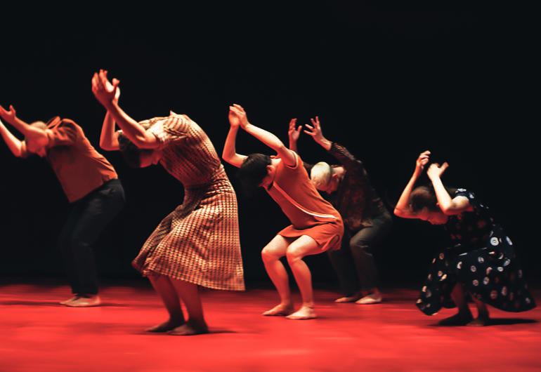 A group of woman dancing in a dramatic way as if they are struggling