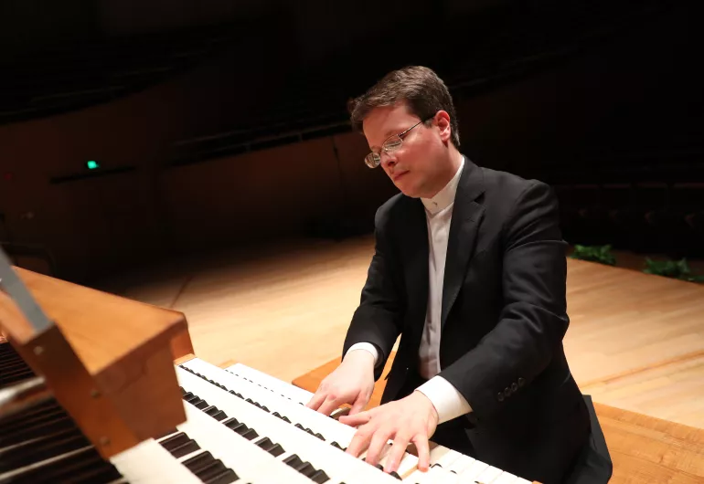 Paul wearing glasses playing the organ