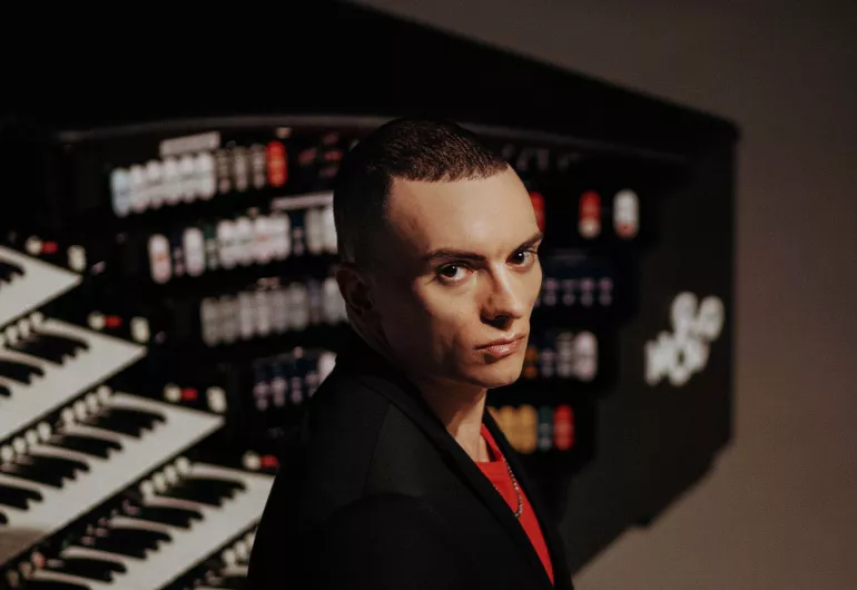 Cameron Carpenter sits in front of his traveling organ