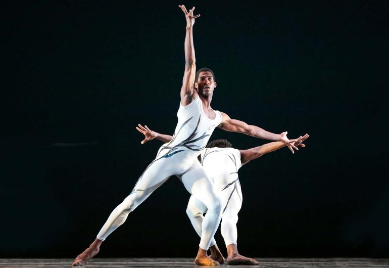 2 dancers in white unitards perform 'Passage'