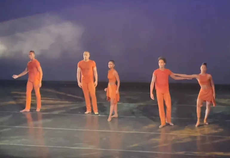 Dance Theatre of Harlem on stage in orange costumes