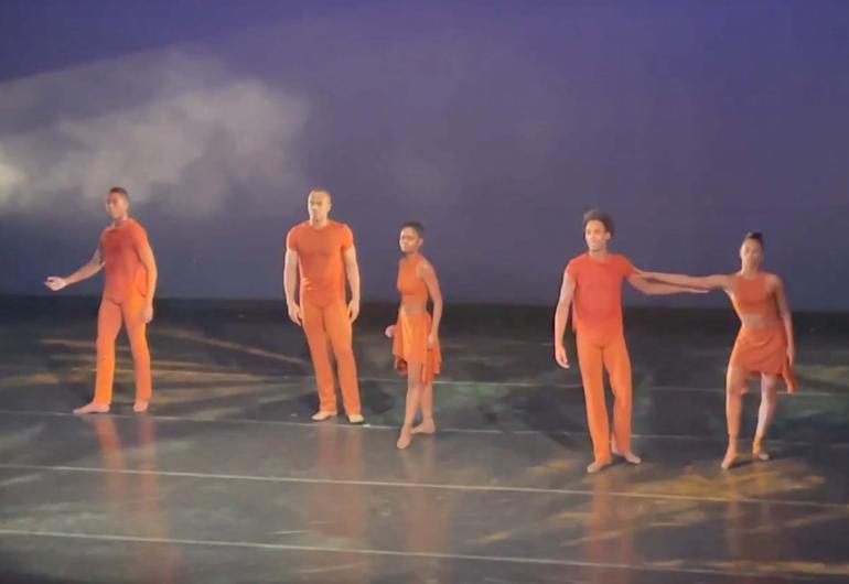 Dance Theatre of Harlem on stage in orange costumes
