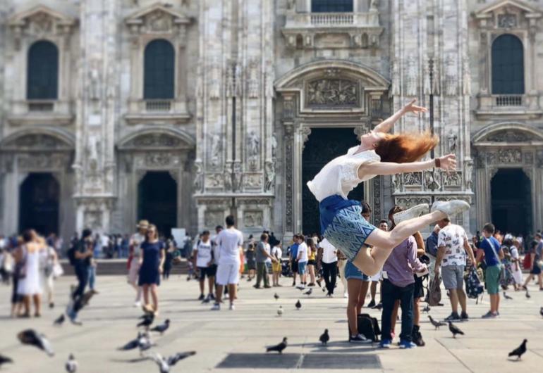 Dancer jumps in a crowded European square