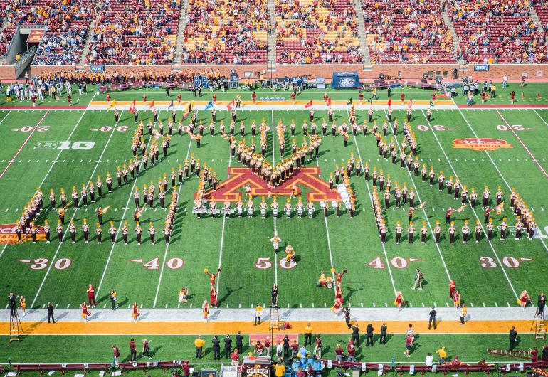 The U of M Marching Band in the "M" formation on the football field