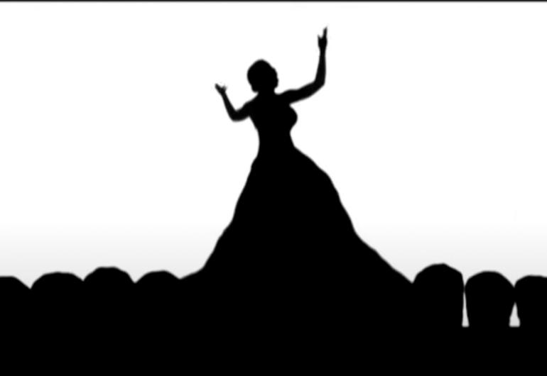shadow silhouette of the shape of a woman in a gown with her arms up and open