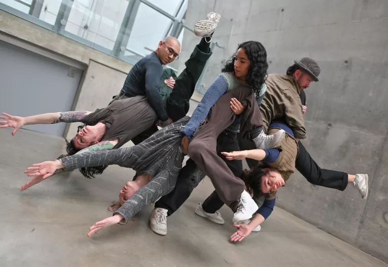 BRKFST dancers hold their partners upside down.