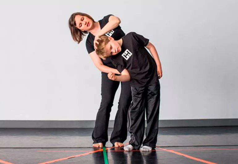 Hubbard Street Dance teacher and student work on movement together.
