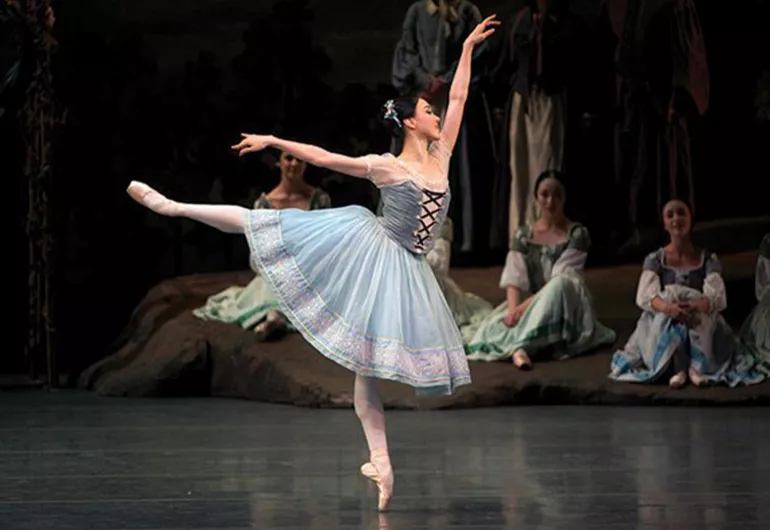 A young woman in a maiden costume dances in the ballet “Giselle” at Northrop.