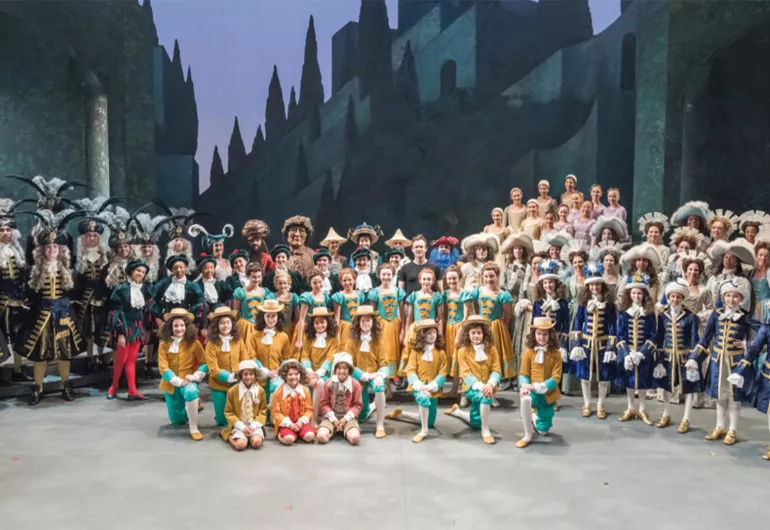 A large group of children and adults in costumes for the ballet “Sleeping Beauty.”