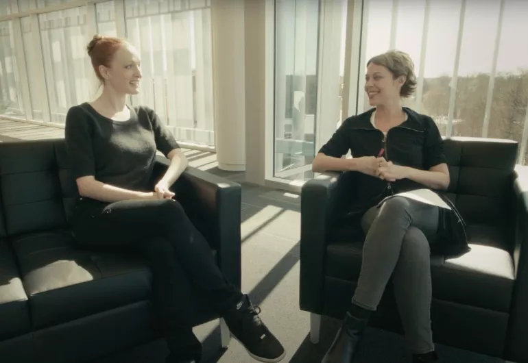 Two women, Gillian Murphy and Susan Jaffe, talk together while sitting in chairs