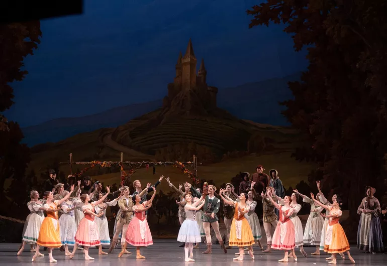 Dancers in medieval costumes perform on stage in “Giselle.”