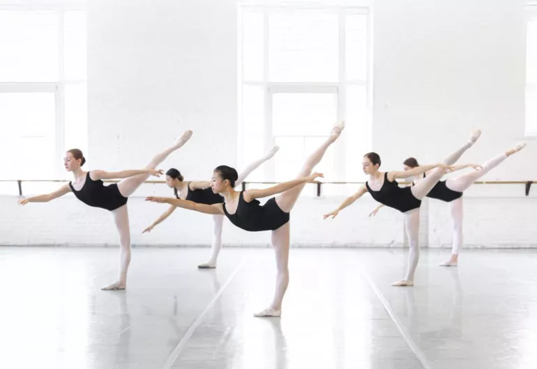 BalletMet Dance Academy students in black leotards dance in a studio.