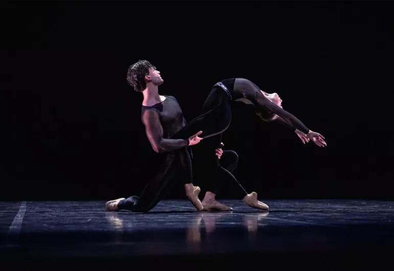 Two dancers in black perform in "Miroirs"