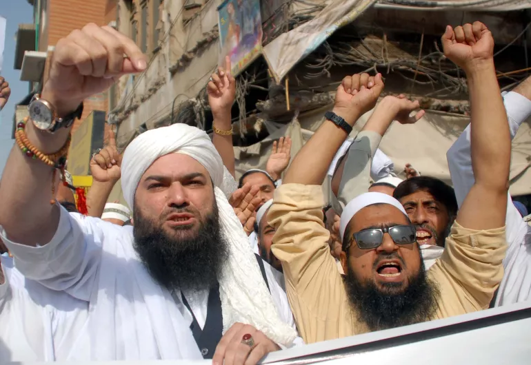 Activists march with fists in the air in Peshawar, Pakistan.