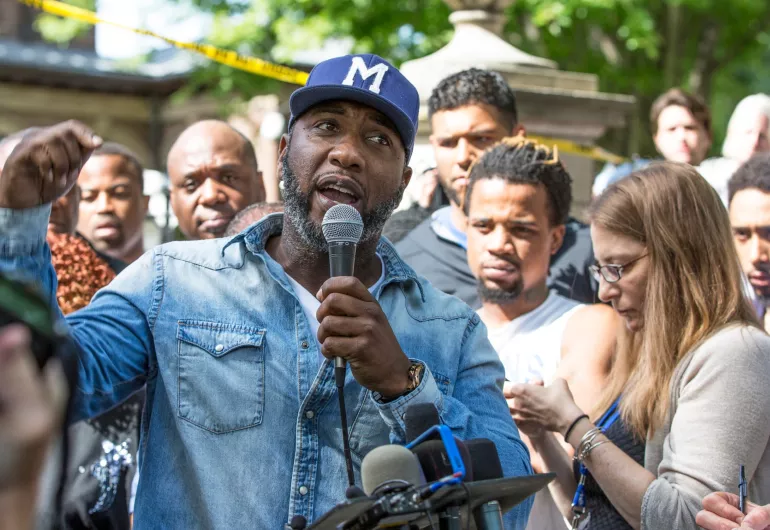 Pastor Danny Givens addresses the crowd at a rally.