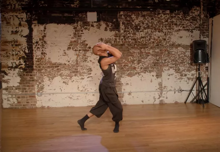 Shamel Pitts dancing in a studio. Link to YouTube, where he discusses his multidisciplinary art.