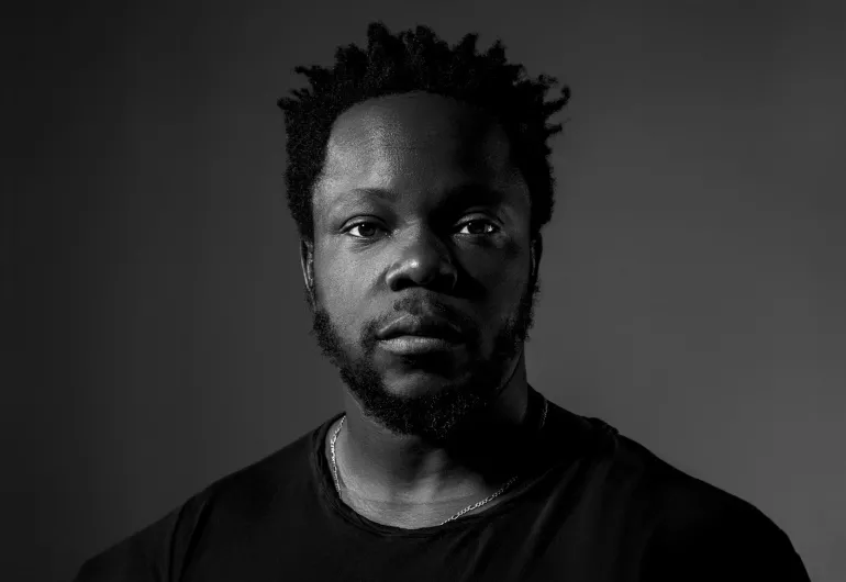 Ambrose Akinmusire, a man with a stoic expression. Image linked to YouTube video.