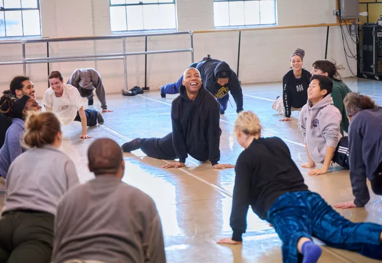 Shamel Pitts leads a dance class among smiling students.