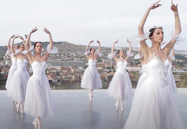 The State Ballet of Georgia ballet dancers on a rooftop in white costumes