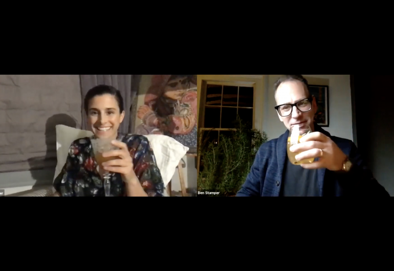 Screen shot of two people on a Zoom call, smiling with beverages