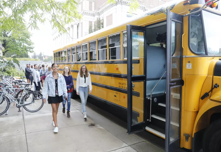 Students walking to a school bus.
