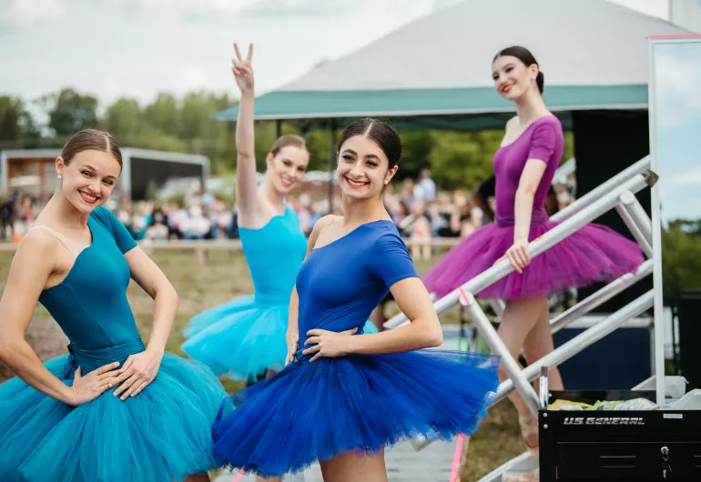 ABT dancers smile for the camera while backstage.