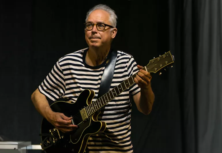 Bill Frisell plays a guitar.