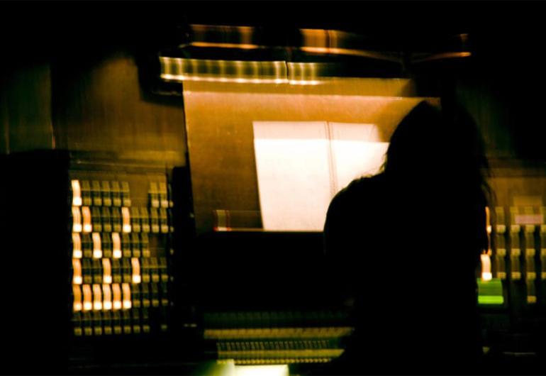 Sarah Davachi playing organ with her back to the camera