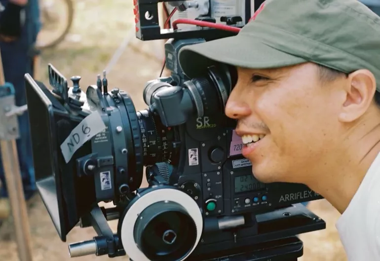 Video still of Apichatpong Weerasethakul on set behind the camera.
