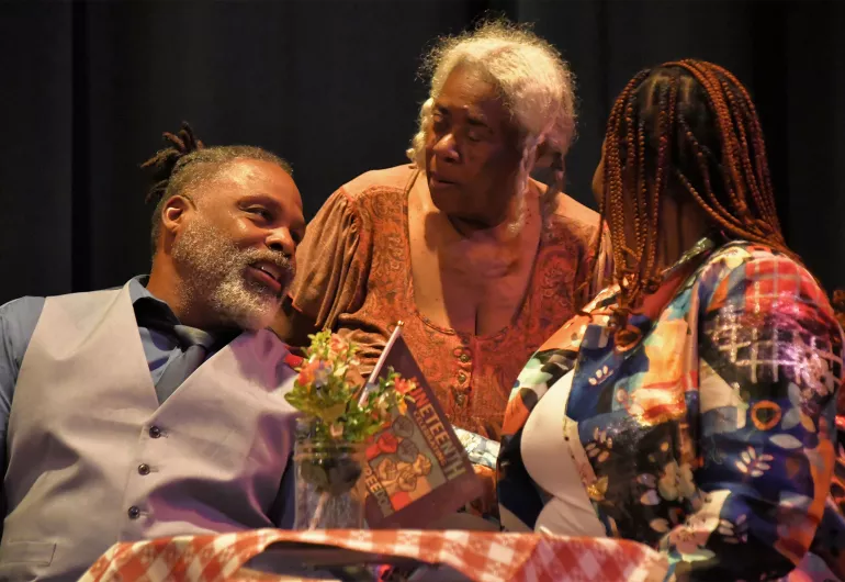 Scene from the play. Captioned below.