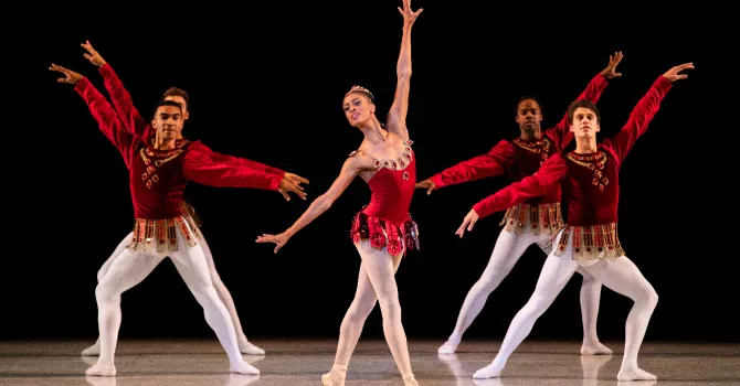 Ballet dancers in red costumes and white tights