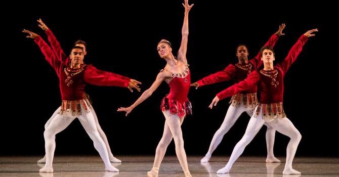 Ballet dancers in red costumes and white tights