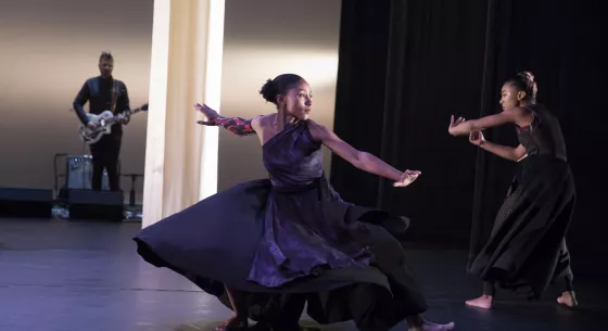 Two female dancers perform on stage.