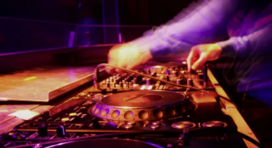 DJ in front of mixing board