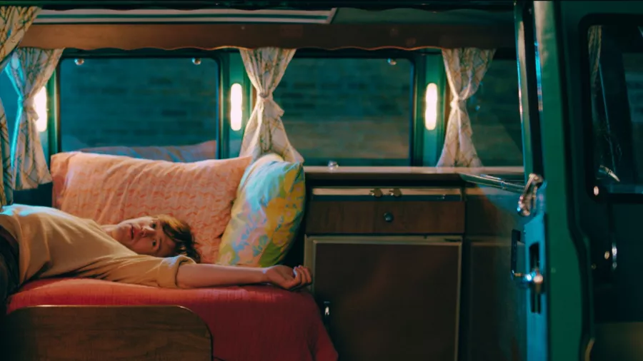 A person lays on a couch.