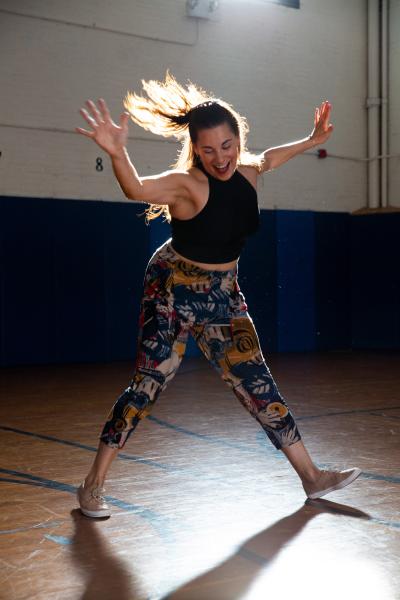 A woman performs Swing 2020 in a gymnasium setting.